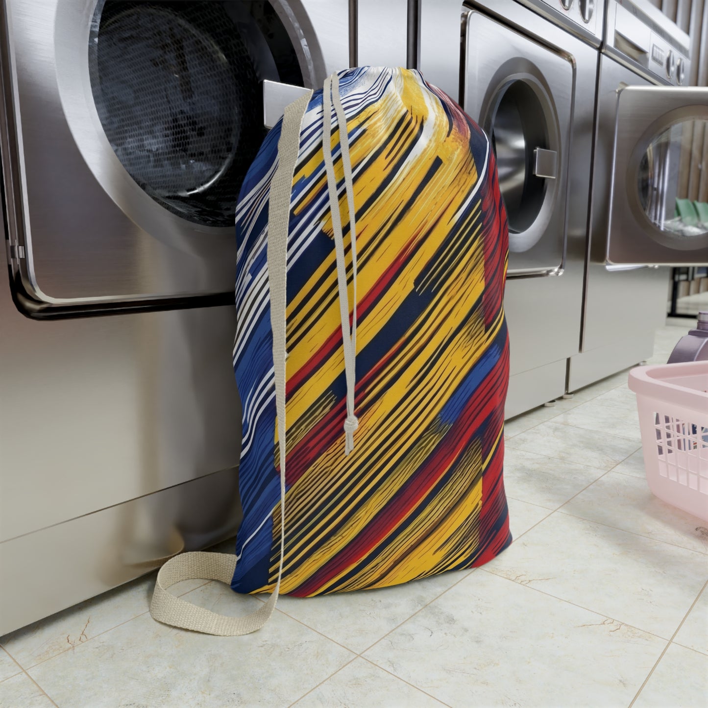 Colorful abstract brushstroke laundry bag in red, yellow, and blue tote for dorms and travel by Printify.